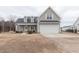 Charming two-story home with a manicured lawn, a two-car garage, and a welcoming front porch at 375 Thomas Arnold Rd, Zebulon, NC 27597