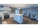 Open kitchen features a large island, stainless steel appliances, and modern cabinetry adjacent to a living space at 375 Thomas Arnold Rd, Zebulon, NC 27597