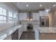 Bright kitchen features a farmhouse sink, granite countertops, stainless appliances, and white cabinetry at 375 Thomas Arnold Rd, Zebulon, NC 27597