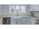 Bright kitchen features a farmhouse sink, white cabinets, granite countertops, subway tile backsplash, and stainless steel appliances at 375 Thomas Arnold Rd, Zebulon, NC 27597
