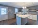 Bright kitchen with white cabinets, an island, butcher block countertops, stainless steel appliances, and modern fixtures at 375 Thomas Arnold Rd, Zebulon, NC 27597