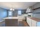 Open kitchen featuring a large island, stainless steel appliances, and modern white cabinetry with butcher block counters at 375 Thomas Arnold Rd, Zebulon, NC 27597