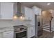 Modern kitchen with stainless steel appliances, granite countertops, white cabinets, and a subway tile backsplash at 375 Thomas Arnold Rd, Zebulon, NC 27597