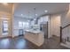 Open concept kitchen featuring an island, granite countertops, stainless appliances, white cabinetry, and view to front door at 375 Thomas Arnold Rd, Zebulon, NC 27597