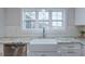 Bright kitchen features a farmhouse sink, white cabinets, granite countertops, subway tile backsplash, and stainless steel appliances at 375 Thomas Arnold Rd, Zebulon, NC 27597
