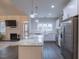 Bright open-concept living room flowing into a kitchen with stainless steel appliances at 375 Thomas Arnold Rd, Zebulon, NC 27597