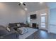 Cozy living room features a fireplace, TV, and access to outdoor balcony at 375 Thomas Arnold Rd, Zebulon, NC 27597