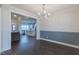 Open floorplan dining area with modern chandelier and a view into kitchen area at 375 Thomas Arnold Rd, Zebulon, NC 27597