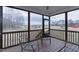 Relax on this screened porch overlooking a large yard with mature trees and playground at 375 Thomas Arnold Rd, Zebulon, NC 27597