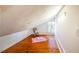 Cozy attic space with hardwood flooring, sloped ceilings, and a bright window at 513 E Franklin St, Chapel Hill, NC 27514