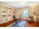 Sunlit home office features built-in bookshelves and a comfortable seating area at 513 E Franklin St, Chapel Hill, NC 27514