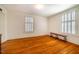 Large room with hardwood floors, two large windows with shutters, and bench seating at 513 E Franklin St, Chapel Hill, NC 27514