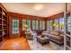 Charming sunroom with wood paneling, hardwood floors, and an abundance of natural light at 513 E Franklin St, Chapel Hill, NC 27514