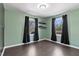 Light-filled bedroom with windows on two walls and dark hardwood flooring at 55 Daniel Harris Rd, Henderson, NC 27537