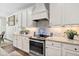 Modern kitchen featuring white cabinets, granite countertops, stainless steel appliances, and tile backsplash at 564 Woodbridge Ct, Wake Forest, NC 27587