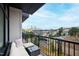 Balcony with sofa, table, metal railing and views of the surrounding neighborhood at 615 Daniels St # 318, Raleigh, NC 27605