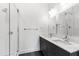 Modern bathroom with double sink vanity, walk-in shower, and neutral finishes at 615 Daniels St # 318, Raleigh, NC 27605