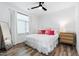 Bright bedroom with hardwood floors, plush bed, and ample natural light at 615 Daniels St # 318, Raleigh, NC 27605