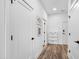 Bright hallway with white walls, wood-look flooring, and several closed doors, plus a white storage cabinet at 615 Daniels St # 318, Raleigh, NC 27605