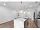 Contemporary kitchen featuring a large island with seating and stainless steel appliances with gray cabinets at 615 Daniels St # 318, Raleigh, NC 27605