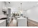 Stylish kitchen featuring gray cabinets, stainless steel appliances, and a large center island with barstool seating at 615 Daniels St # 318, Raleigh, NC 27605