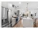 Modern kitchen with stainless steel appliances, gray cabinets, and a white quartz countertop island with pendant lights at 615 Daniels St # 318, Raleigh, NC 27605