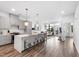 Bright kitchen with stainless steel appliances, gray cabinets, and a large center island with pendant lighting and seating at 615 Daniels St # 318, Raleigh, NC 27605
