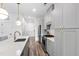 Contemporary kitchen featuring a large island with seating, modern lighting, and stainless steel appliances at 615 Daniels St # 318, Raleigh, NC 27605