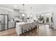 Open concept kitchen featuring gray cabinets, stainless steel appliances, and a large center island with seating at 615 Daniels St # 318, Raleigh, NC 27605