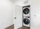Laundry closet with modern, stacked washer and dryer at 615 Daniels St # 318, Raleigh, NC 27605