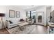 Bright living room with balcony access, neutral tones, stylish decor, and wood flooring at 615 Daniels St # 318, Raleigh, NC 27605