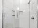 Walk-in shower featuring white subway tile and a glass door at 615 Daniels St # 318, Raleigh, NC 27605