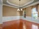 Dining room with hardwood floors, large windows, and a decorative chandelier at 627 Aylestone Dr, Cary, NC 27519