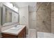 Contemporary bathroom with a sink, modern mirror, and tiled shower and tub at 6423 New Market Way, Raleigh, NC 27615