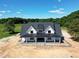 An aerial of the home showcasing its expansive lot, mature trees, architectural details and serene setting at 6509 Zebulon Rd, Wake Forest, NC 27587