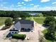 Aerial view of modern farmhouse and wooded lake at 6509 Zebulon Rd, Wake Forest, NC 27587