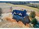 New construction home with a dark metal roof and wrap around porch on a large lot at 6509 Zebulon Rd, Wake Forest, NC 27587