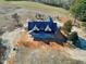 New construction home with a dark metal roof and wrap around porch on a large lot at 6509 Zebulon Rd, Wake Forest, NC 27587