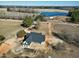 Custom home featuring metal roof near pond with expansive acreage and mature trees at 6509 Zebulon Rd, Wake Forest, NC 27587