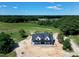 Aerial view of modern farmhouse in rural wooded location at 6509 Zebulon Rd, Wake Forest, NC 27587