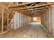 Framed attic area with exposed beams and a window for natural light at 6509 Zebulon Rd, Wake Forest, NC 27587
