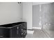 Modern bathroom featuring sleek tile floors and walls, and a stylish vanity at 6509 Zebulon Rd, Wake Forest, NC 27587