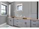 Bathroom features gray cabinets, ample storage, and natural light from the window at 6509 Zebulon Rd, Wake Forest, NC 27587