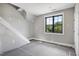 Bright bedroom featuring a large window offering natural light and a view of the outdoors at 6509 Zebulon Rd, Wake Forest, NC 27587