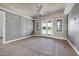 Spacious bedroom with tray ceiling, ceiling fan, large windows, and french doors to the backyard at 6509 Zebulon Rd, Wake Forest, NC 27587