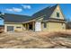 Exterior view of a yellow house with a garage and sliding glass doors to the covered patio at 6509 Zebulon Rd, Wake Forest, NC 27587