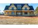 Spacious two-story house with black trim and a metal roof situated on a large lot at 6509 Zebulon Rd, Wake Forest, NC 27587
