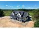 New modern farmhouse featuring metal roof, white siding, and inviting covered porch at 6509 Zebulon Rd, Wake Forest, NC 27587