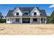 Stunning new construction home with a welcoming front porch and modern farmhouse design at 6509 Zebulon Rd, Wake Forest, NC 27587