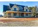 Spacious two-story house with black trim and a metal roof situated on a large lot at 6509 Zebulon Rd, Wake Forest, NC 27587